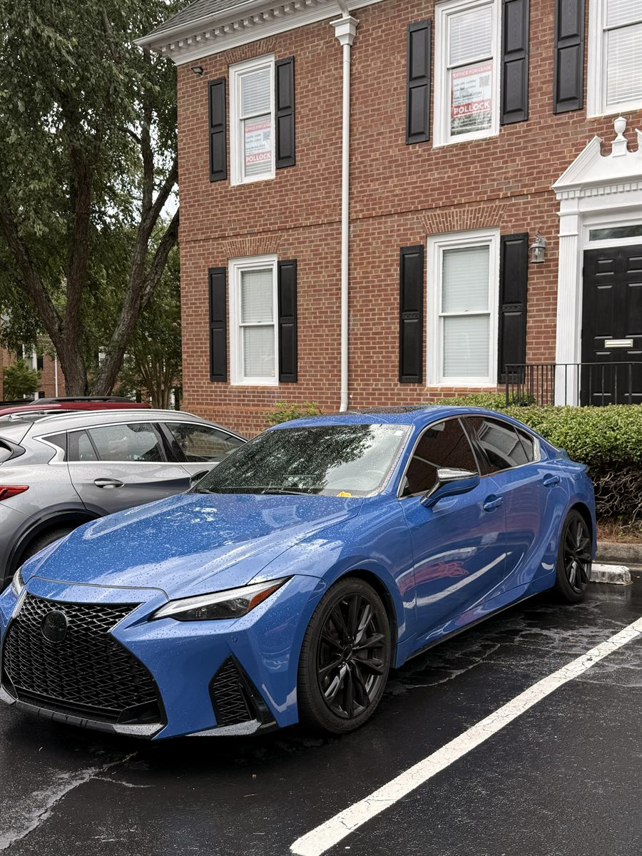 Lexus IS sedan with tinted glass parked outside after installation