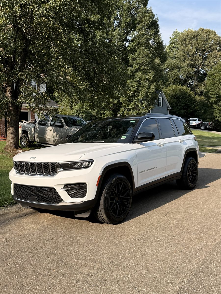 Jeep Grand Cherokee with tinted glass and blacked-out trim and wheels