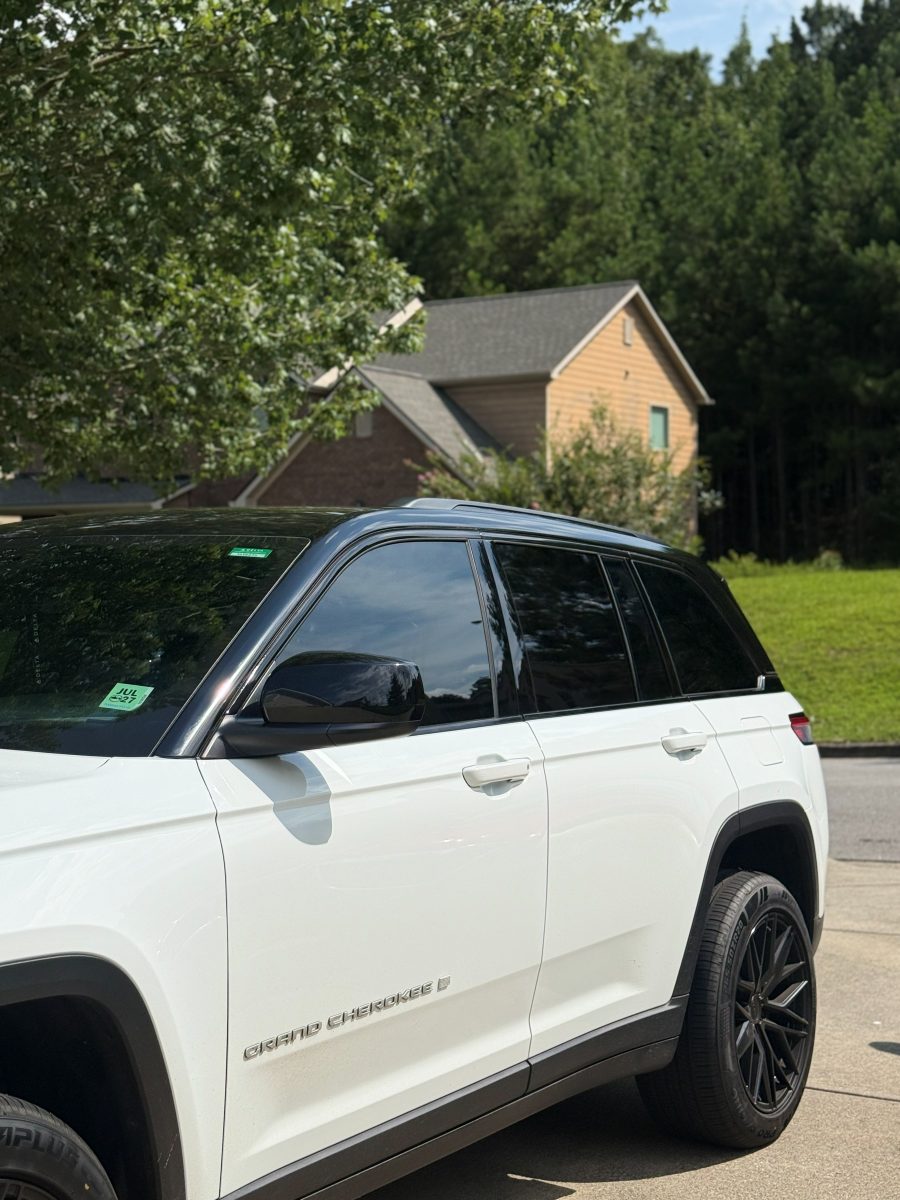 White Jeep Grand Cherokee with window surrounds, pillars and roof rails blacked out